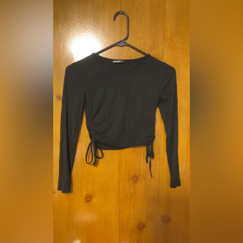 Long sleeve, tight fitted, black, side scrunch, partial crop top.